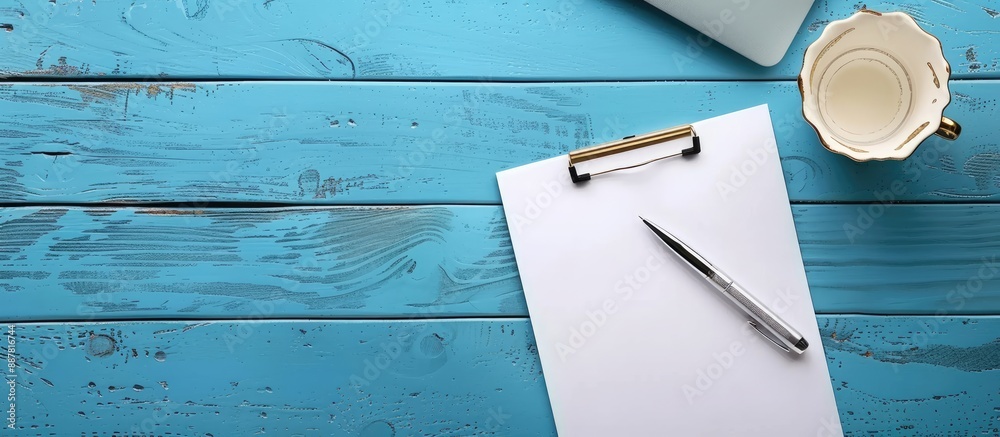 Aufkleber business desk concept with a pen on a blue wooden background an empty sheet of paper a glass of drin