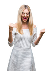 Young beautiful blonde woman wearing glasses over isolated background very happy and excited doing winner gesture with arms raised, smiling and screaming for success. Celebration concept.