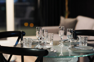 Glass table Dining table setting in a luxury apartment hotel room close up 