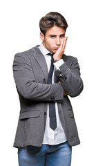 Young business man wearing suit and tie over isolated background thinking looking tired and bored with depression problems with crossed arms.