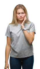 Young caucasian woman over isolated background touching mouth with hand with painful expression because of toothache or dental illness on teeth. Dentist concept.