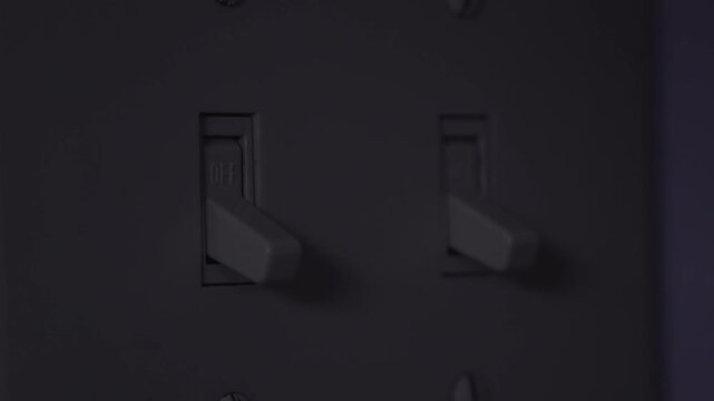 Close up of light switch being flipped on and off 4k
