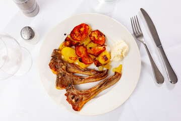 Grilled lamb rib chop steaks, medium rare with french fries on a plate