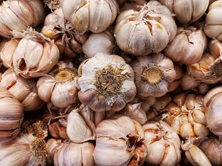 Pile of fresh garlic bulbs for sale at the supermarket in Indonesia.