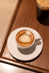 a cup of coffee with a heart-shaped design in the foam