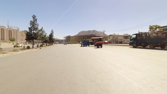Kabul, Afghanistan - 14th october, 2024: right-side driving point of view in sunny Kabul heavy traffic city center road. POV hyperlapse travel adventure in Afghanistan