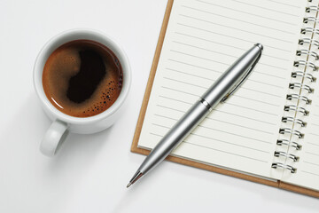 Coffee and notebook with pen