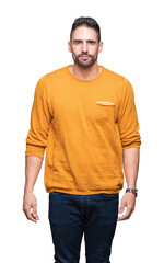 Obraz premium Young handsome man over isolated background Relaxed with serious expression on face. Simple and natural looking at the camera.