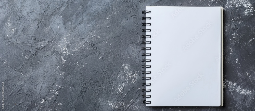 Poster Spiral notebook on grey backdrop for business office or education themes Ideal for adding content or as a mock up with copy space image Top view