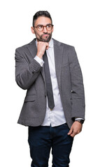 Fototapeta premium Young handsome business man over isolated background with hand on chin thinking about question, pensive expression. Smiling with thoughtful face. Doubt concept.