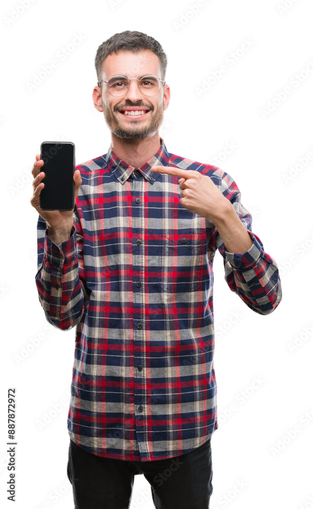 Canvas Prints Young hipster adult man talking on the phone very happy pointing with hand and finger