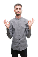 Young hipster man relax and smiling with eyes closed doing meditation gesture with fingers. Yoga concept.