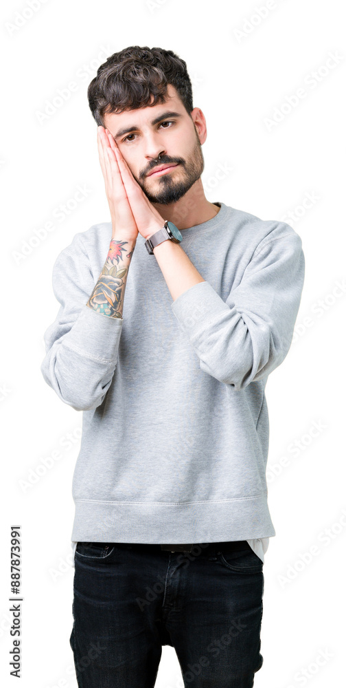 Sticker young handsome man wearing sweatshirt over isolated background sleeping tired dreaming and posing wi