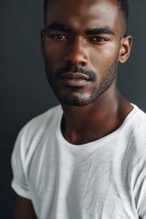 Fototapeta premium hyper realistic photograph of a handsome african american man in a white t-shirt looking directly at the camera.