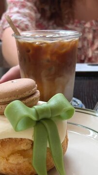 dessert with green bow and macaroon cake custard inside eclair