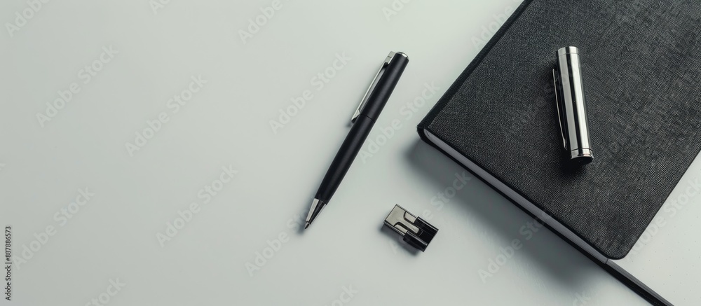 Poster Top view of a corporate themed box containing a pen flash drive and notebook set against a plain white background with copy space image