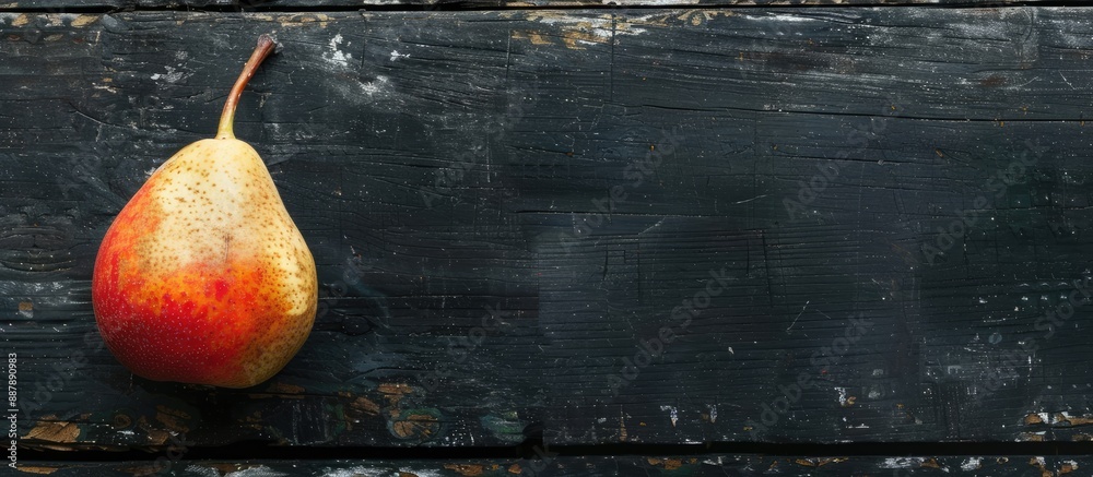 Leinwandbilder top view of a pear on a black wooden table with a blank space for text or images. with copy space im