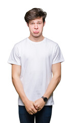 Young handsome man wearing casual white t-shirt over isolated background depressed and worry for distress, crying angry and afraid. Sad expression.