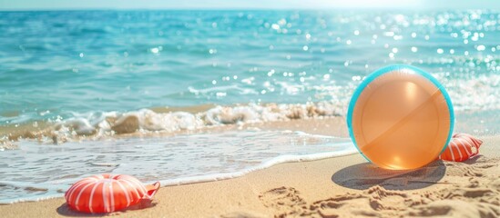 Obraz premium Copy space image showing inflatable ball and beach items on sandy shore by the sea