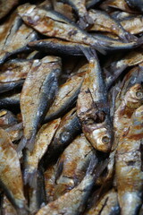 Dried sardines are displayed and being sold on a dry fish market, Salted sardines are on sale at a local Asian seafood market, Closeup shot of freshly caught dried seafood
