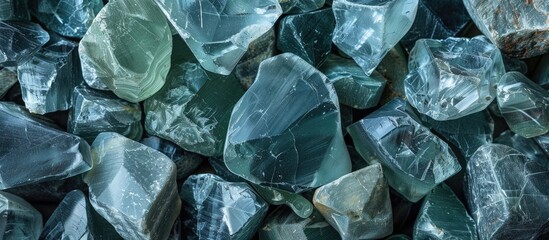 Raw glass rocks with various sizes and patterns viewed from above creating a sharp and edgy background suitable for decorative purposes with ample copy space image