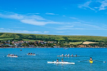 Fototapeta premium People in kayaks on Swanage Bay, Swanage, Dorset, England