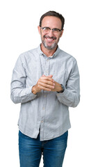 Fototapeta premium Handsome middle age elegant senior man wearing glasses over isolated background Hands together and fingers crossed smiling relaxed and cheerful. Success and optimistic