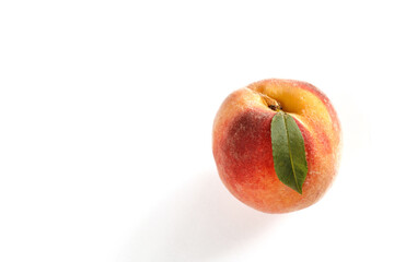 Ripe peach on clean white surface.