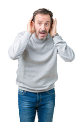 Naklejka premium Handsome middle age senior man wearing a sweatshirt over isolated background Trying to hear both hands on ear gesture, curious for gossip. Hearing problem, deaf