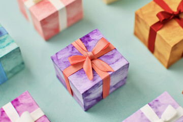 Colorful gift boxes wrapped in vibrant paper and topped with ribbons, arranged neatly. Ideal for festive celebrations, birthdays, or holiday gifting.