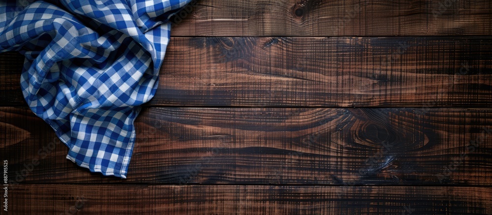 Aufkleber Aerial view of a dark wooden table adorned with a blue checkered tablecloth featuring ample copy space for customization