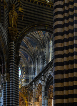 light rays coming through a window in an ols italian church in siena 