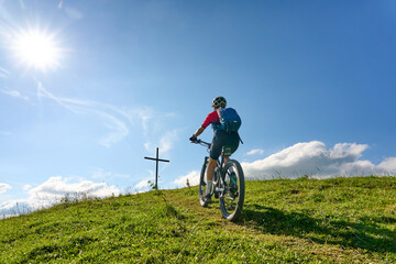 Fototapeta premium nice active senior woman riding her electric mountain bike at Mount Huendle in Oberstaufen, Allgaeu Alps , Bavaria, Germany
