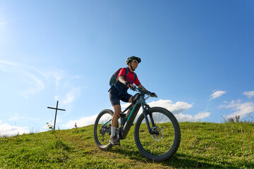 nice active senior woman riding her electric mountain bike at Mount Huendle in Oberstaufen, Allgaeu Alps , Bavaria, Germany