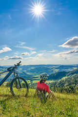 Obraz premium nice active senior woman riding her electric mountain bike at Mount Huendle in Oberstaufen, Allgaeu Alps , Bavaria, Germany