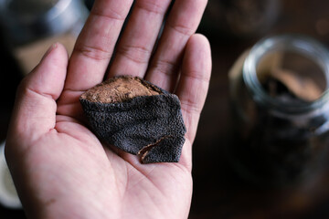 selective focus, good quality Dried orange peel in hand in a herbal tea shop