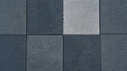 Fototapeta premium The paving slabs are square in shape. Square paving slabs of different colors
