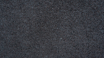 A dark grey asphalt road. Sidewalk path