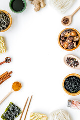 Chinese and Japanese food cooking with ginger, spices and noodles frame on white background top view mock up