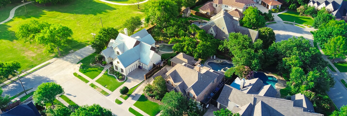 Panorama aerial view suburban park lush green trees, concrete walking path in wealthy residential neighborhood large mansion houses, swimming pool, concrete roof tile, Dallas Fort Worth metroplex