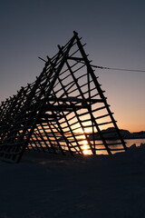 Wooden Structure Silhouetted Against Sunset