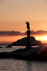 Sunset Silhouette of Coastal Statue