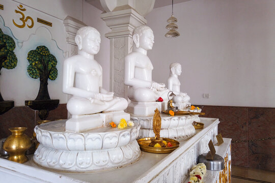 A Divine view of beautifully sculpted Jain Gods 'Mahavira, Santhinatha and Ananthanath' in white marble stone at a Jain pilgrimage in India.