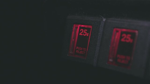 Arcade machine with quarter inserted into coin slot 4k
