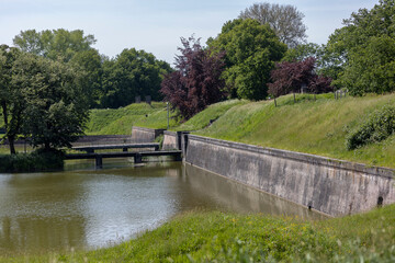 Reinforced walls of Naarden Vesting in the Netherlands with armory and retaining wall embedded in part of protective dike structure Dutch Waterlinie infrastructure