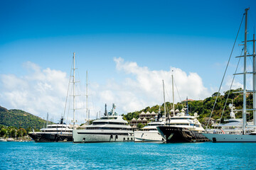 Beautiful mega and superyachts at dock in English Harbour, a famous caribbean island of Antigua know for yacht season