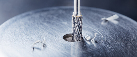 Milling cutter make sink in hole in steel billet. Locksmith work.