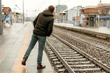 Man Standing On Train Platform Awaiting Arrival