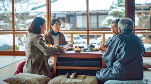 a Japanese family sitting around a kotatsu (heated table) enjoying a meal and conversation during winter, Families in Japan, Japanese culture, everyday life, multigenerational fami