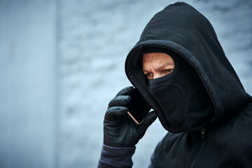 Mask, thief or man with phone call for talking, provide instructions and demand ransom for complete...